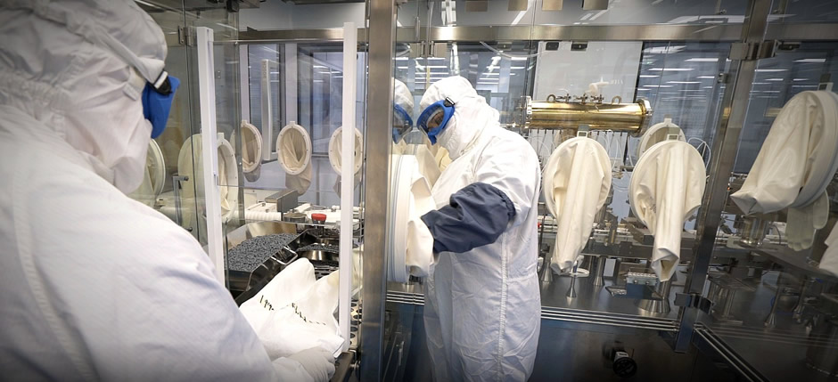 Filling specialists load plunger bowls during aseptic processing