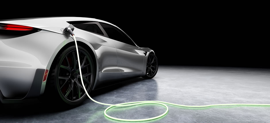 A silver electric sports car charging against a black background