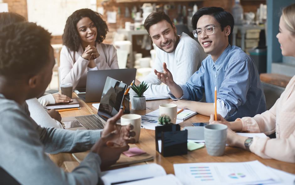 Tech workers discussing projects in a meeting