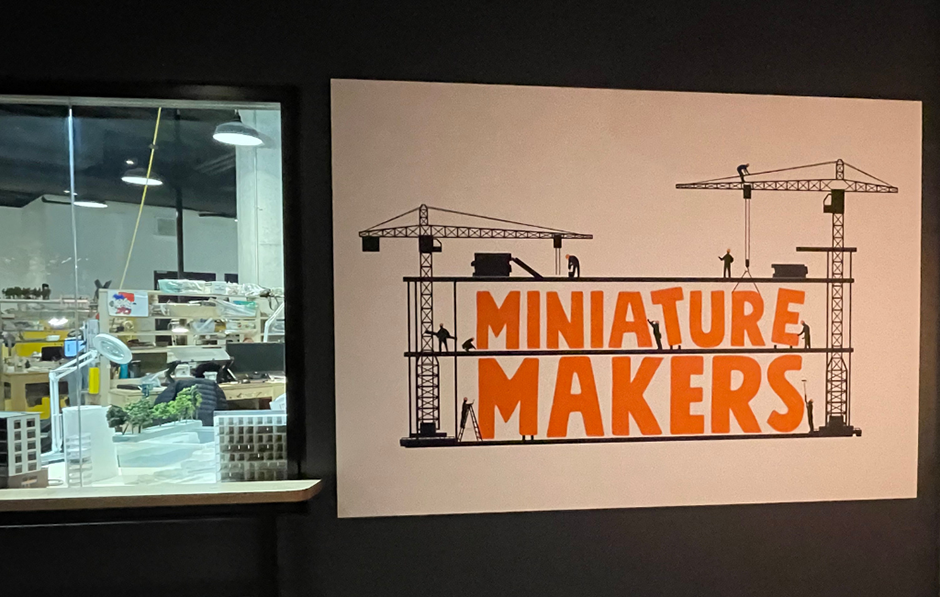 An exposed window that shows the model makers at Little Canada at work.