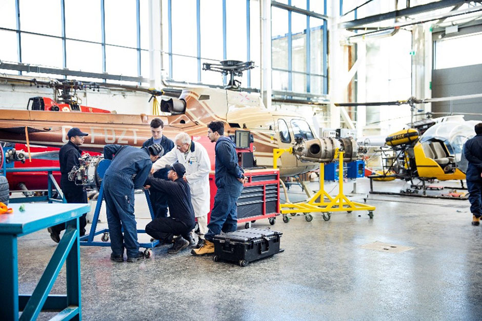 Students working on aerospace equipment at Centennial College.